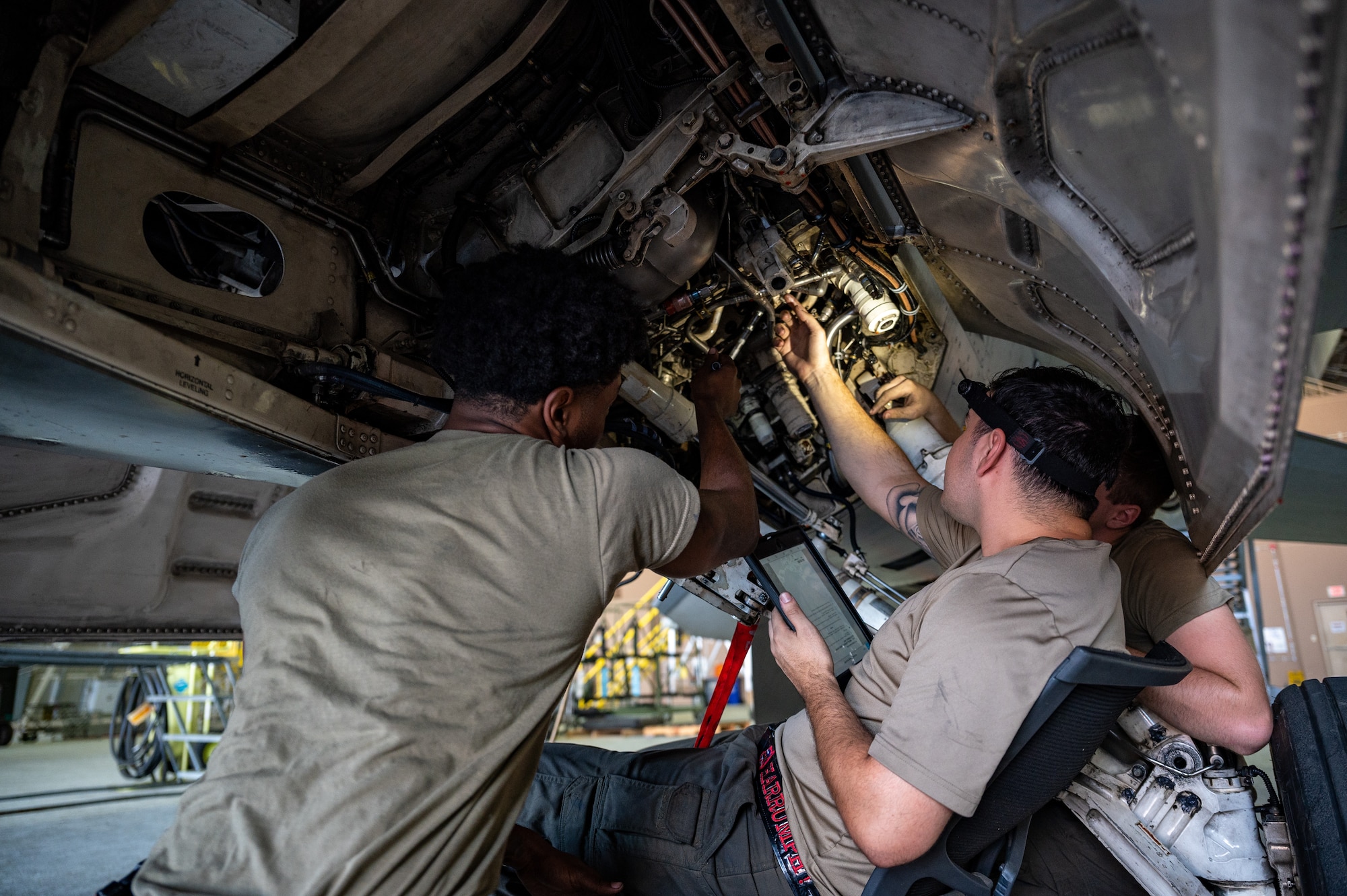From the left, U.S. Air Force Senior Airman Alchenaan Raines, 36th Fighter Generation Squadron aircraft inspection apprentice, Staff Sgt. Mark Garza, 36th FGS aircraft inspection journeyman, and Airman 1st Class Reid Widmann, 36th FGS aircraft inspection apprentice, conduct routine maintenance on an F-16 Fighting Falcon at Osan Air Base, Republic of Korea, Sept. 6, 2023. The 36th FGS holds a crucial role in advancing pilot training and development within the 36th Fighter Squadron by maintaining the operational readiness of their aircraft. This training keeps 36 FS pilots agile, sharp, and fully prepared to defend the ROK. (U.S. Air Force photo by Staff Sgt. Thomas Sjoberg)