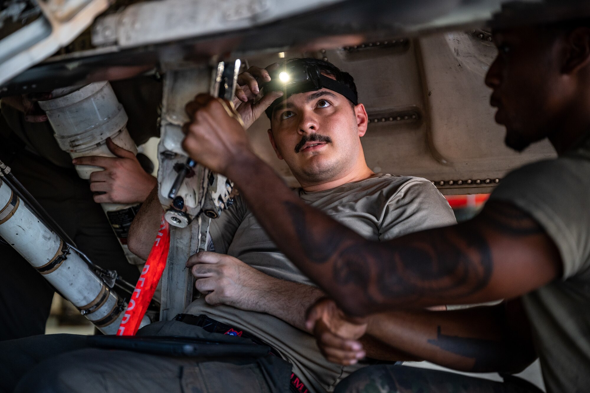 U.S. Air Force Staff Sgt. Mark Garza, 36th Fighter Generation Squadron aircraft inspection journeyman, adjusts his headlamp while conducting routine maintenance on an F-16 Fighting Falcon at Osan Air Base, Republic of Korea, Sept. 6, 2023. Maintaining the F-16s assigned to the 36th Fighter Squadron is the primary responsibility of the 36th FGS. Keeping these F-16s in operational condition enables the 36th FS to fulfill the mission of the 51st Fighter Wing to safeguard the skies over the ROK. (U.S. Air Force photo by Staff Sgt. Thomas Sjoberg)