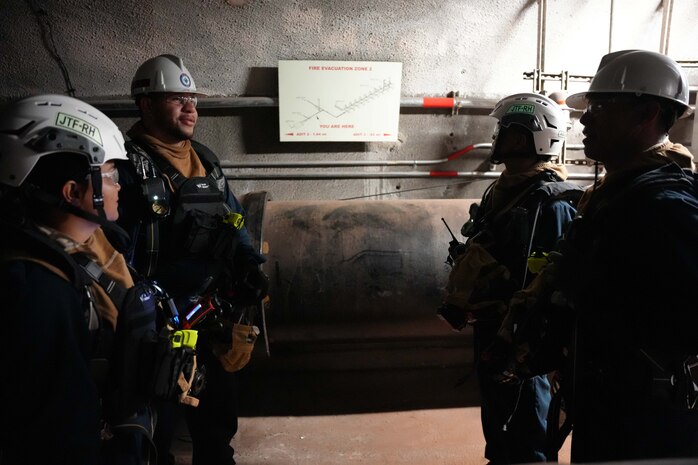 With one team starting at Adit 5 and another starting at Adit 1, Joint Task Force-Red Hill (JTF-RH) roving security and fire watch teams meet at the halfway point while on patrol at the Red Hill Bulk Fuel Storage Facility (RHBFSF), Halawa, Hawaii, Sep. 6, 2023. JTF-RH roving security and fire watch teams began 24-hour surveillance of the RHBFSF during fuel line repacking operations last month and will continue through completion of gravity defueling. (DoD photo by U.S. Air National Guard Tech. Sgt. Nicholas Brown)
