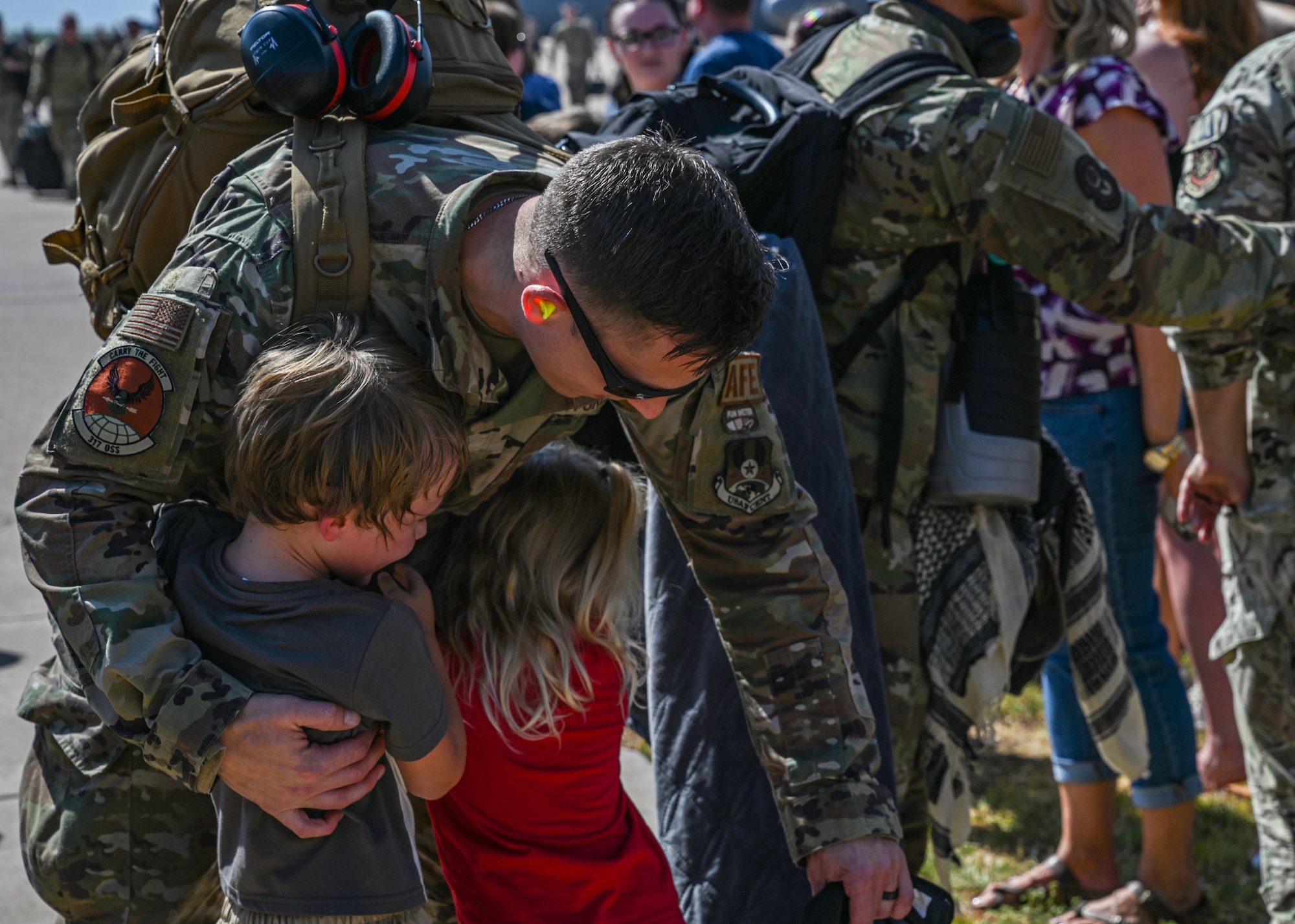 An Airman from the 317th Operational Support Squadron embraces loved ones.