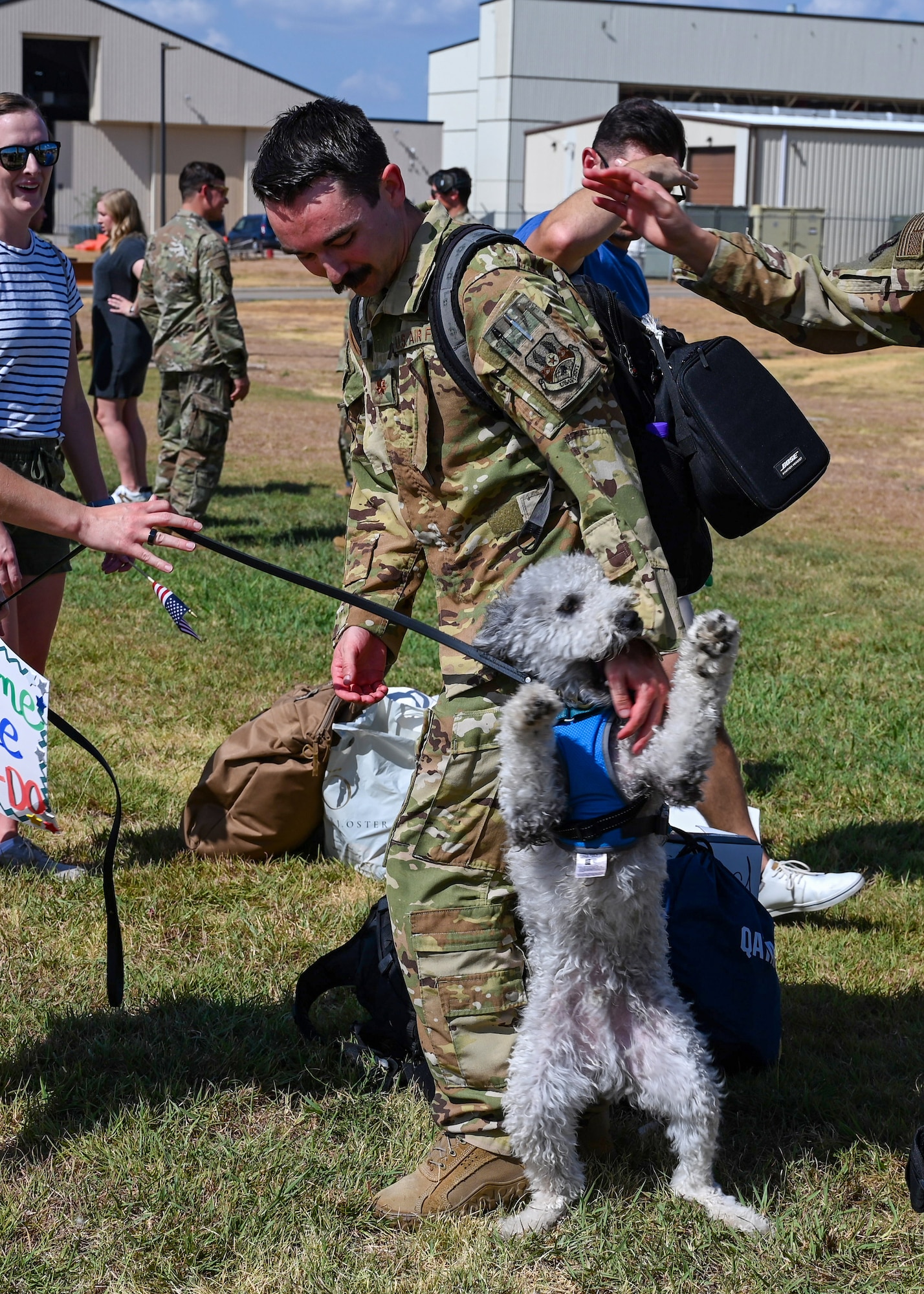 An Airman from the 317th Airlift Wing embraces his dog