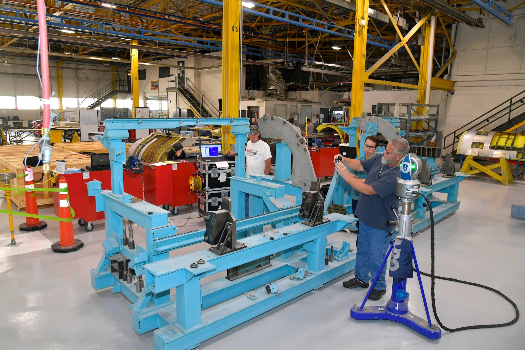 (Right to left) Jay Hudson, Metrology and Calibration Flight technician, and Richard Thompson, MCF summer intern, and Brian Wilson, MCF dimensional work lead, check tolerances on a jig fixture used for building A-10 fuselage sections. Machine inspections and calibrations are accomplished on thousands of machines throughout the installation each year by personnel in the 809th Maintenance Support Squadron. (U.S. Air Force photo by Todd Cromar)