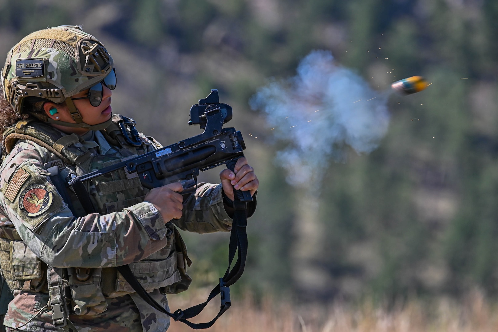 Airman 1st Class Jermalie Rosario, 91st Missile Security Forces Squadron defender, fires 40mm high explosive rounds from an M320 Grenade Launcher Module (GLM) during Operation Frontier Thunder at Camp Guernsey, Wyoming, Aug. 29, 2023. The M320 GLM allows defenders to engage armored and soft targets at a range of up to 400 meters. (U.S. Air Force photo by Airman 1st Class Kyle Wilson)