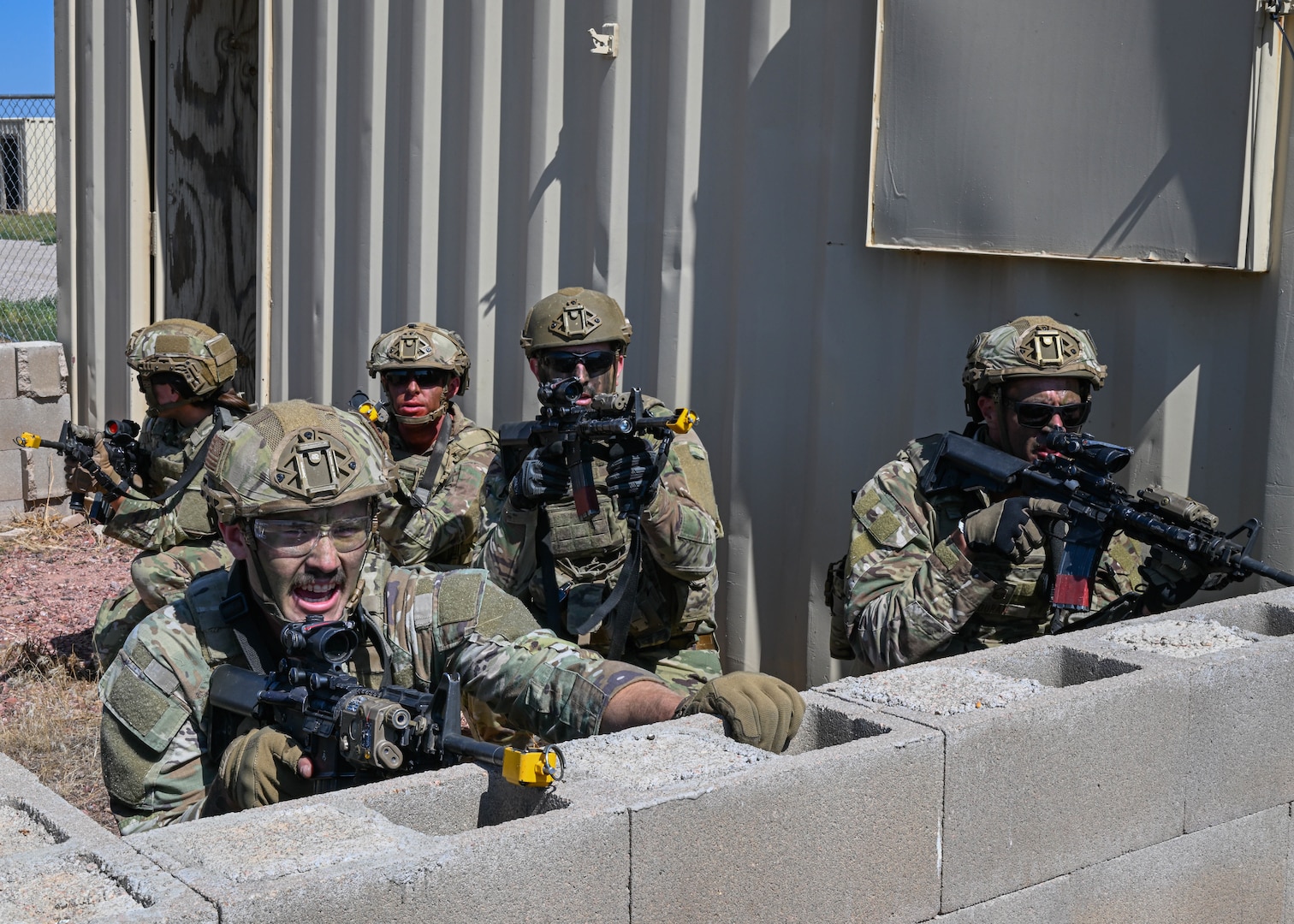 Defenders assigned to the 91st Missile Security Forces Squadron (MSFS) take cover while assaulting a simulated opposing force outpost during Operation Frontier Thunder at Camp Guernsey, Wyoming, Aug. 31, 2023. Operation Frontier Thunder tested Airmen of the 91st MSFS in various close quarters battle scenarios. (U.S. Air Force photo by Airman 1st Class Kyle Wilson)