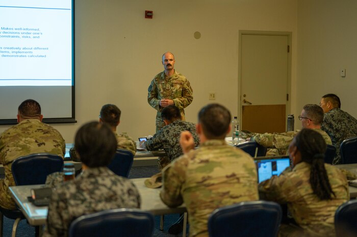 Senior Master Sgt. Kyle Rollins  speaks with U.S. Airmen and Koku Jieitai attending the SNCO Professional enhancement seminar.