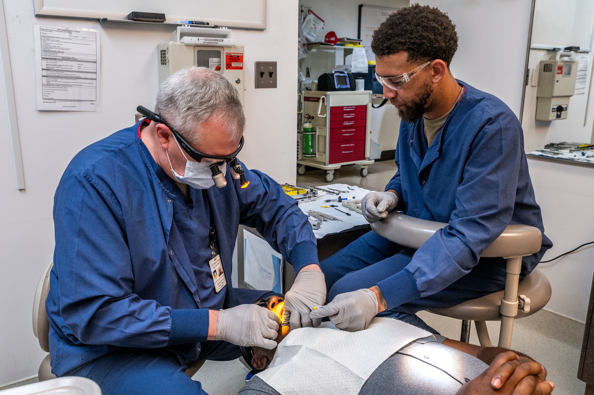 U.S. Air Force Lt. Col. Thomas Edmonson, left, 51st Operational Medical Readiness Squadron dentist, and Staff Sgt. Quinlan Taylor Kasey, 51st OMRS dental assistant, treat a patient at Osan Air Base, Republic of Korea, Sep. 6, 2023.