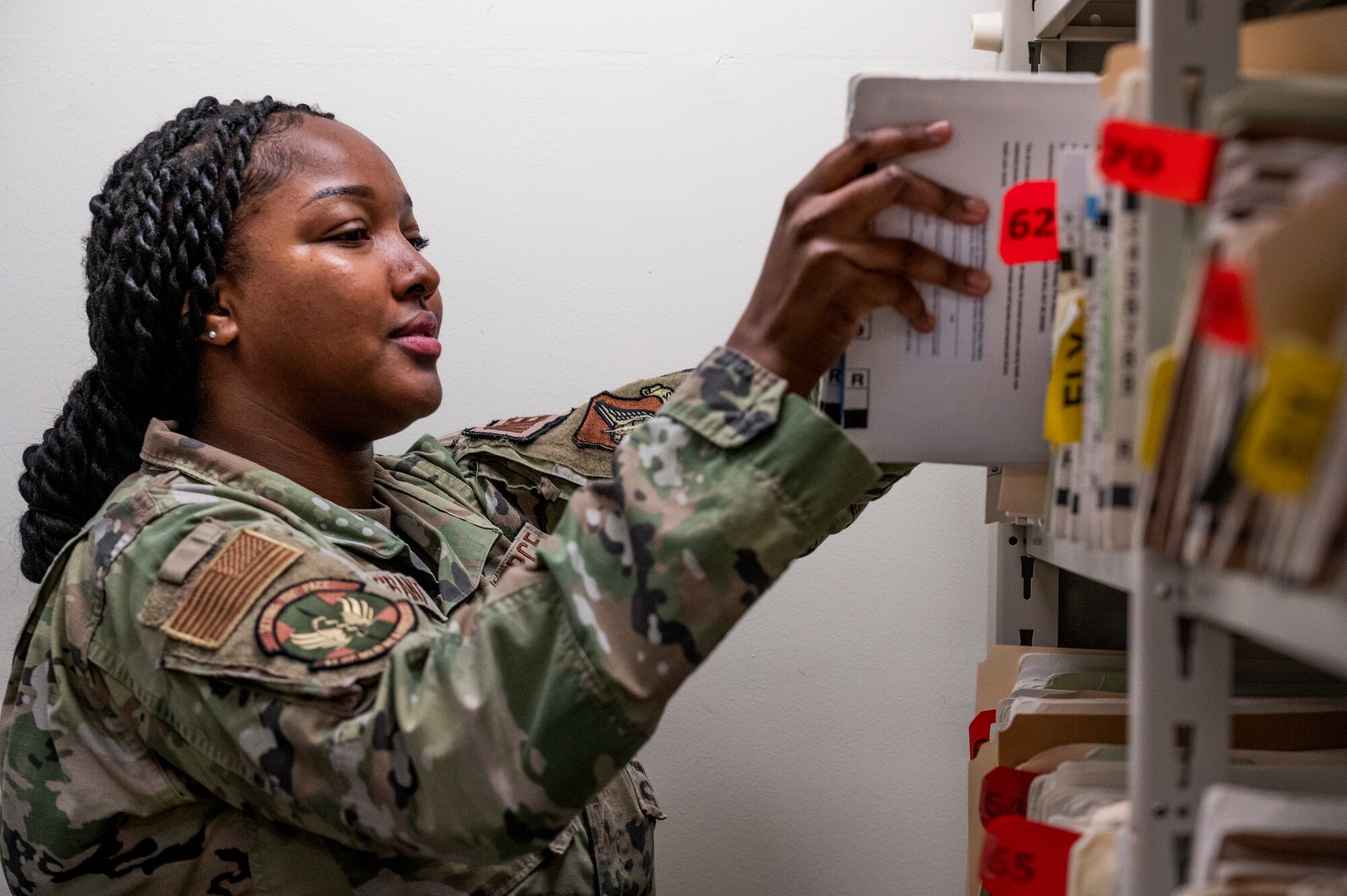 U.S. Air Force Staff Sgt. Gelyn Grant, 51st Operational Medical Readiness Squadron dental flight front desk NCOIC, retrieves dental files at Osan Air Base, Republic of Korea, Sep. 6, 2023.
