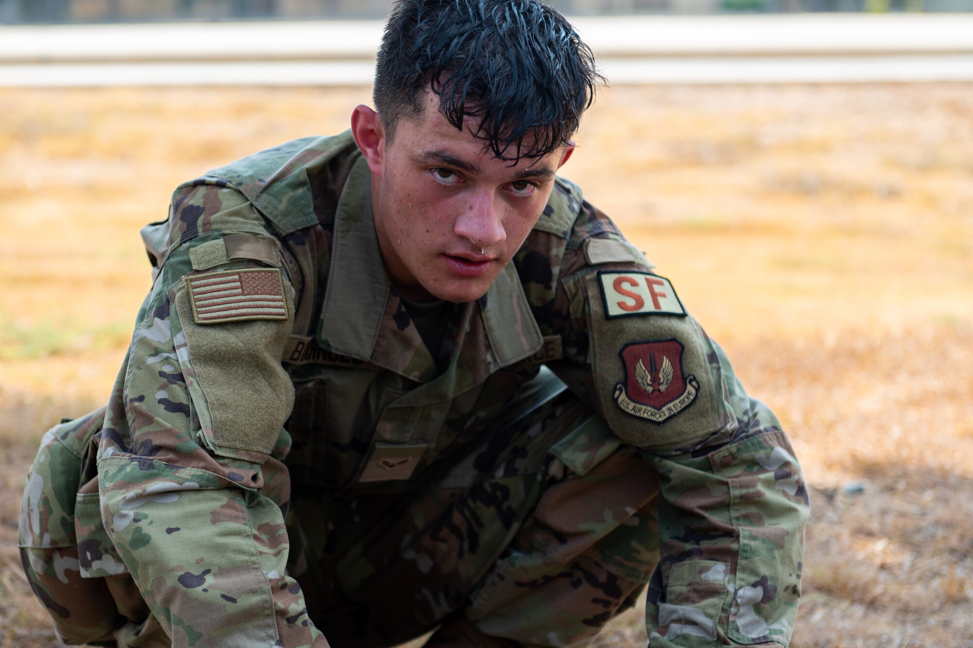 An Airman crouching to catch his breath.