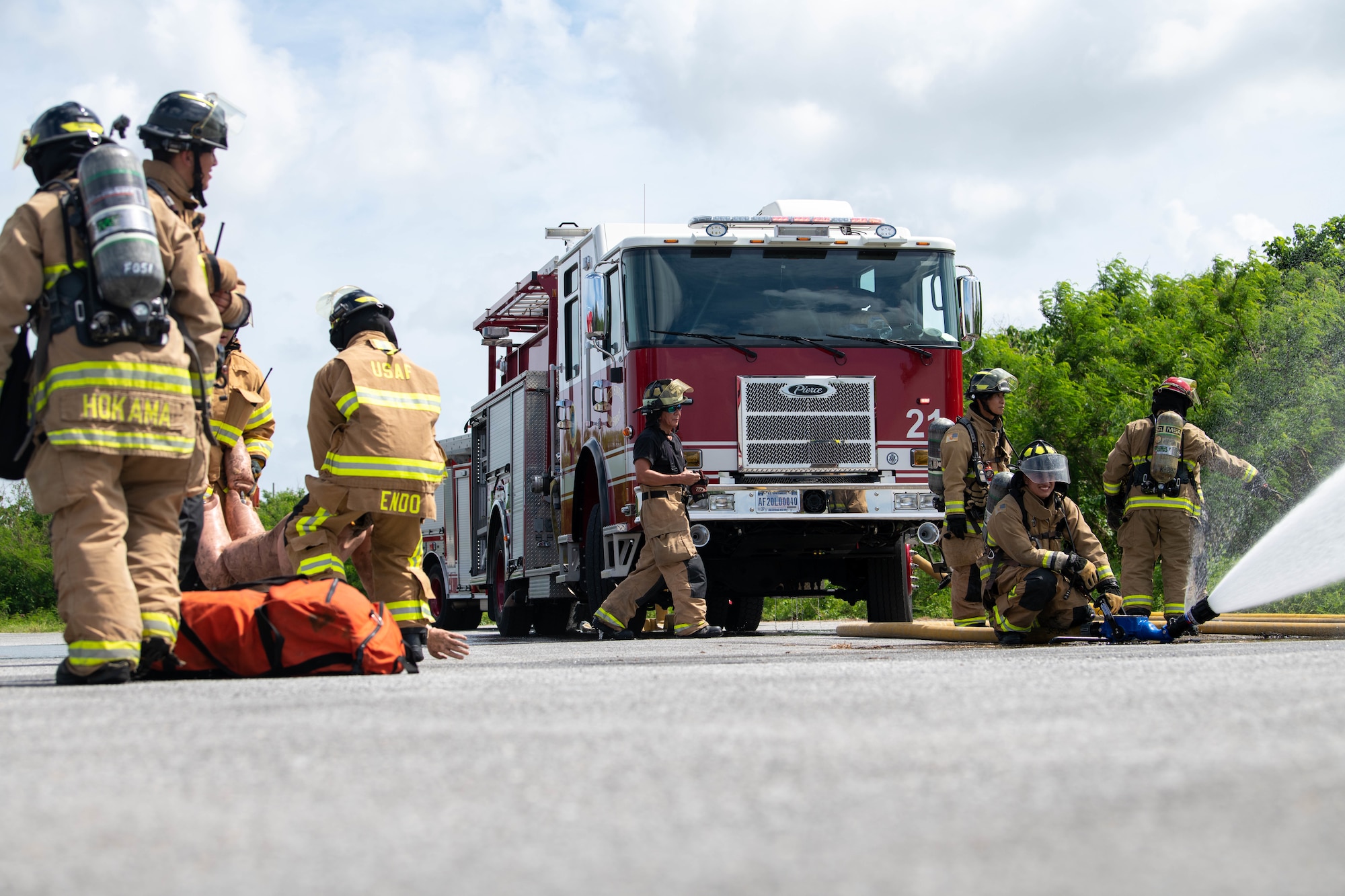 A group of 18th CES Firemen conduct a structure fire exercise