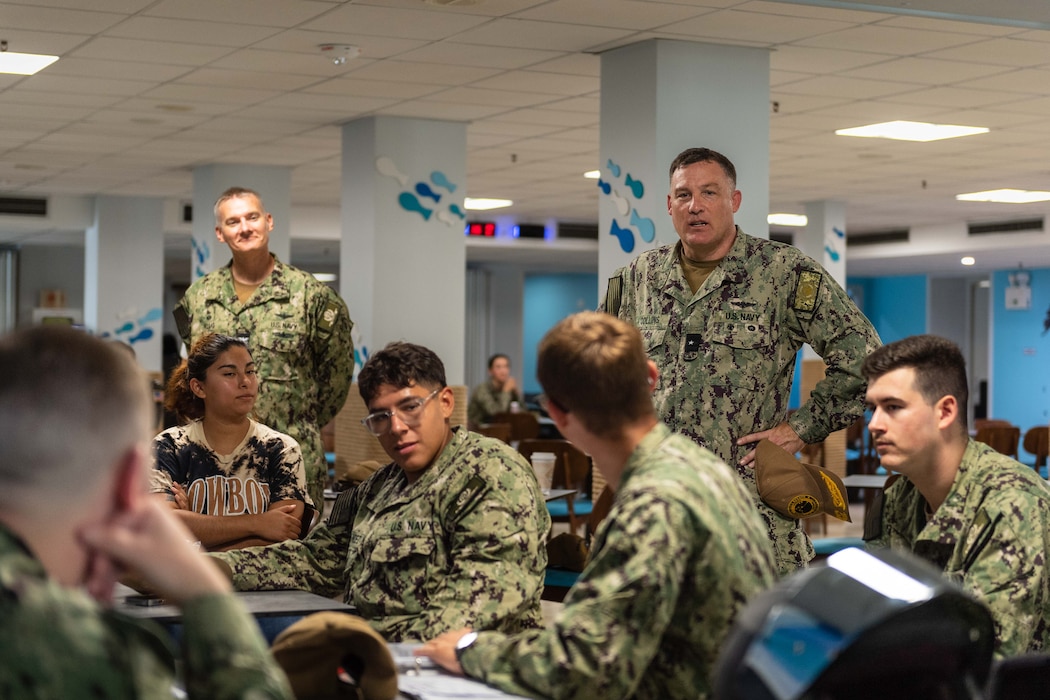 Rear Adm. Brad J. Collins, commander, Navy Region Europe, Africa, Central, addresses questions posed by Sailors assigned to Naval Support Activity Souda Bay during a Coalition of Sailors Against Destructive Decisions meeting, Sept. 7, 2023.