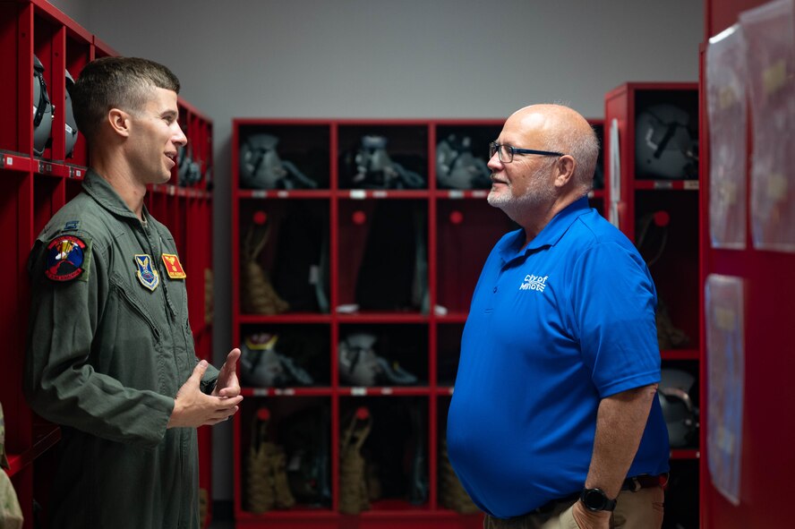 U.S. Air Force Capt. Levi Hilgenhold, 23rd Bomb Squadron B-52H Stratofortress pilot, speaks with the Honorable Tom Ross, mayor of Minot, North Dakota, at Minot Air Force Base, North Dakota, Sept. 5, 2023. Hilgenhold toured the mayor through the Aircrew Flight Equipment (AFE) room during his ground training prior to his incentive flight. (U.S. Air Force photo by Senior Airman Zachary Wright)