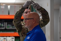 U.S. Air Force Airman 1st Class Zachary Riggins, 5th Operations Support Squadron aircrew flight equipment (AFE) technician, sizes flight equipment for the Honorable Tom Ross, mayor of Minot, North Dakota, at Minot Air Force Base, North Dakota, Sept. 5, 2023. Training on AFE equipment is required for all members flying on the B-52H Stratofortress in order to ensure the flight crew’s safety. (U.S. Air Force photo by Senior Airman Zachary Wright)