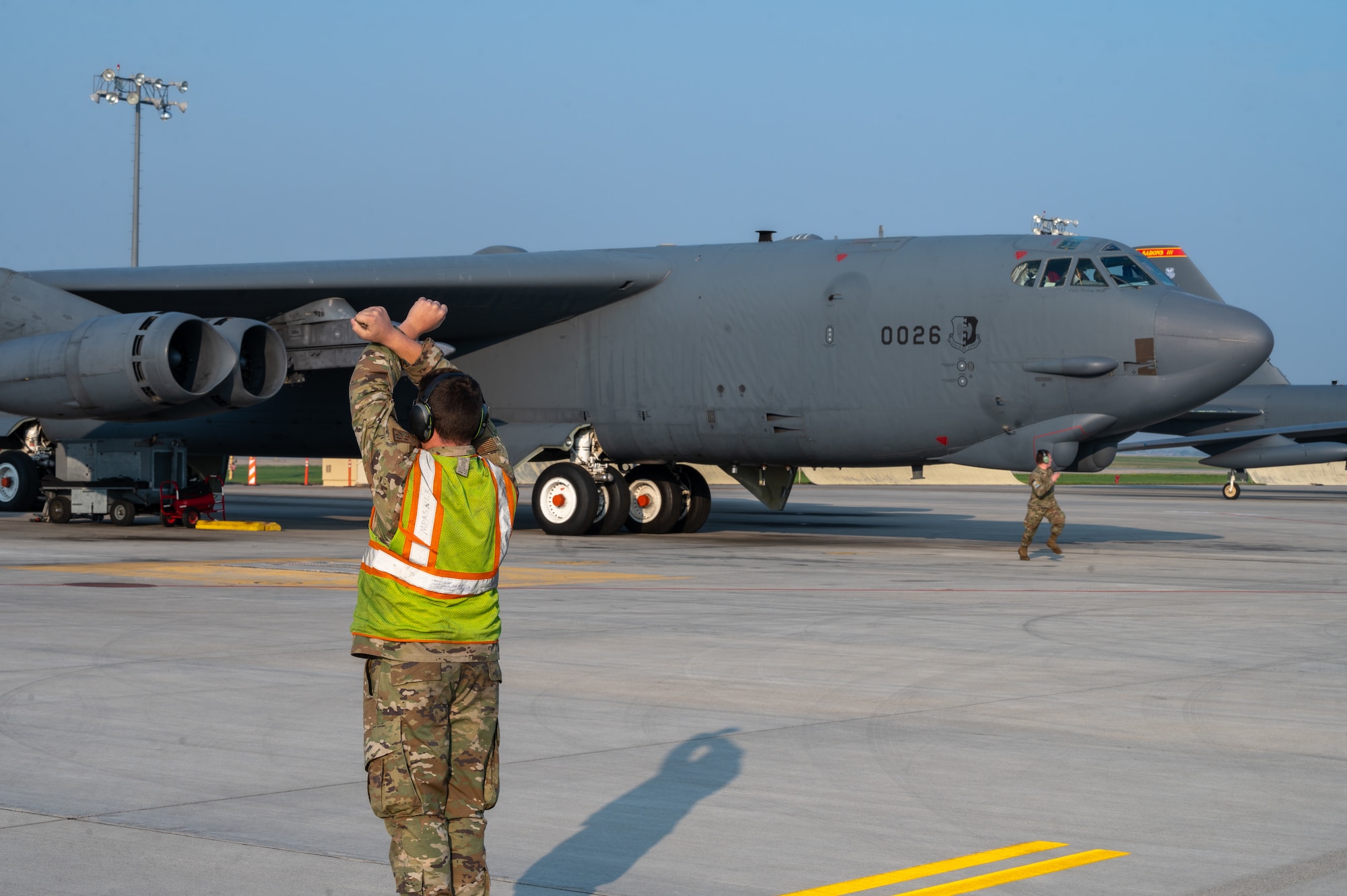 A B-52H Stratofortress, assigned to the 5th Bomb Wing, is ushered to taxi on to the main parking apron at Minot Air Force Base, North Dakota, Sept. 6, 2023. The B-52H Stratofortress has eight Pratt & Whitney TF33-P-3 turbofan engines, each providing more than 17,000lb of thrust. (U.S. Air Force Photo by Airman 1st Class Alexander Nottingham)