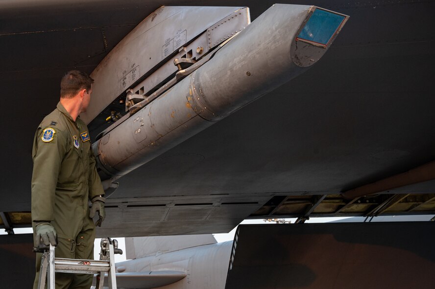 U.S. Air Force Capt. Dylan Collins, 23rd Bomb Squadron weapon systems operator, checks the targeting pod as a part of pre-flight procedures on a B-52H Stratofortress at Minot Air Force Base, North Dakota, Sept. 6, 2023. The Targeting pod provides improved long-range target detection, identification and continuous stabilized surveillance for all missions, including close air support of ground forces. (U.S. Air Force Photo by Airman 1st Class Alexander Nottingham)