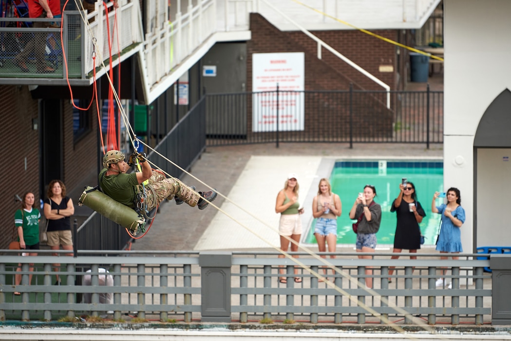 A U.S. Air Force pararescueman executes an urban high-angle ropes scenario to reach a simulated injured service member, render medical care, and lower him to safety during the PJ Rodeo competition in Louisville, Ky., Sept. 6, 2023. The biennial event, which tests the capabilities of pararescue Airmen across the service, was hosted by the Kentucky Air National Guard’s 123rd Special Tactics Squadron. (U.S. Air National Guard photo by Phil Speck)