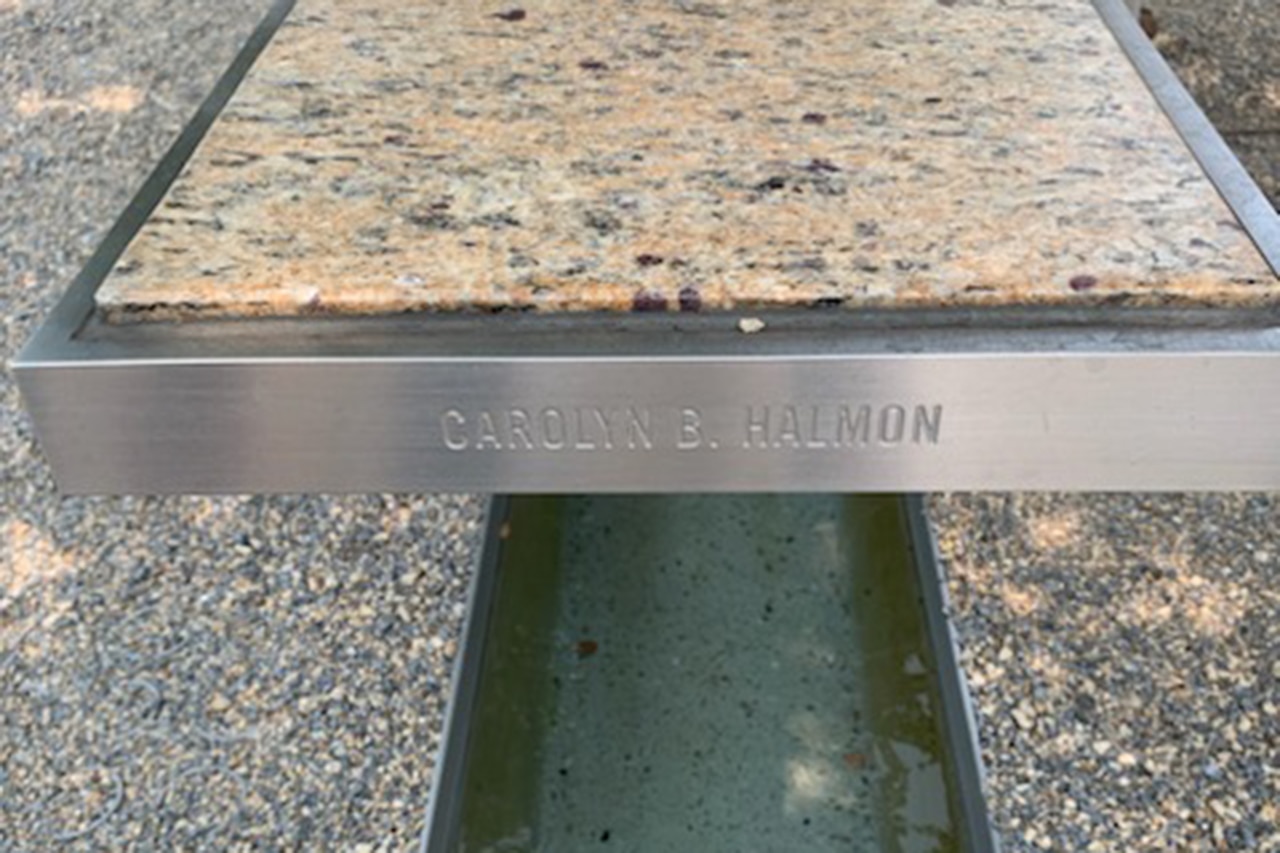 A bench shows the inscription “Carolyn B. Halmon.”