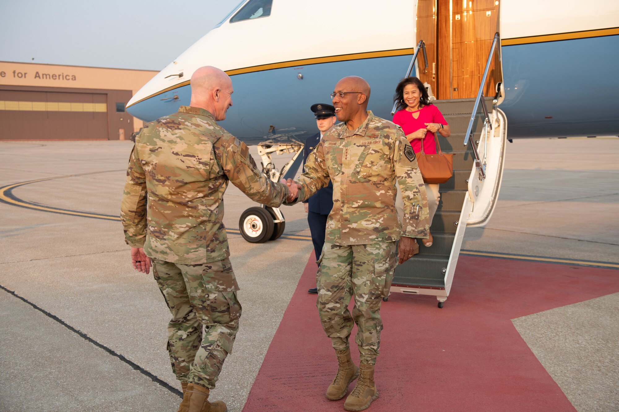 CSAF greeted by Col Mark Howard after stepping off airplane.