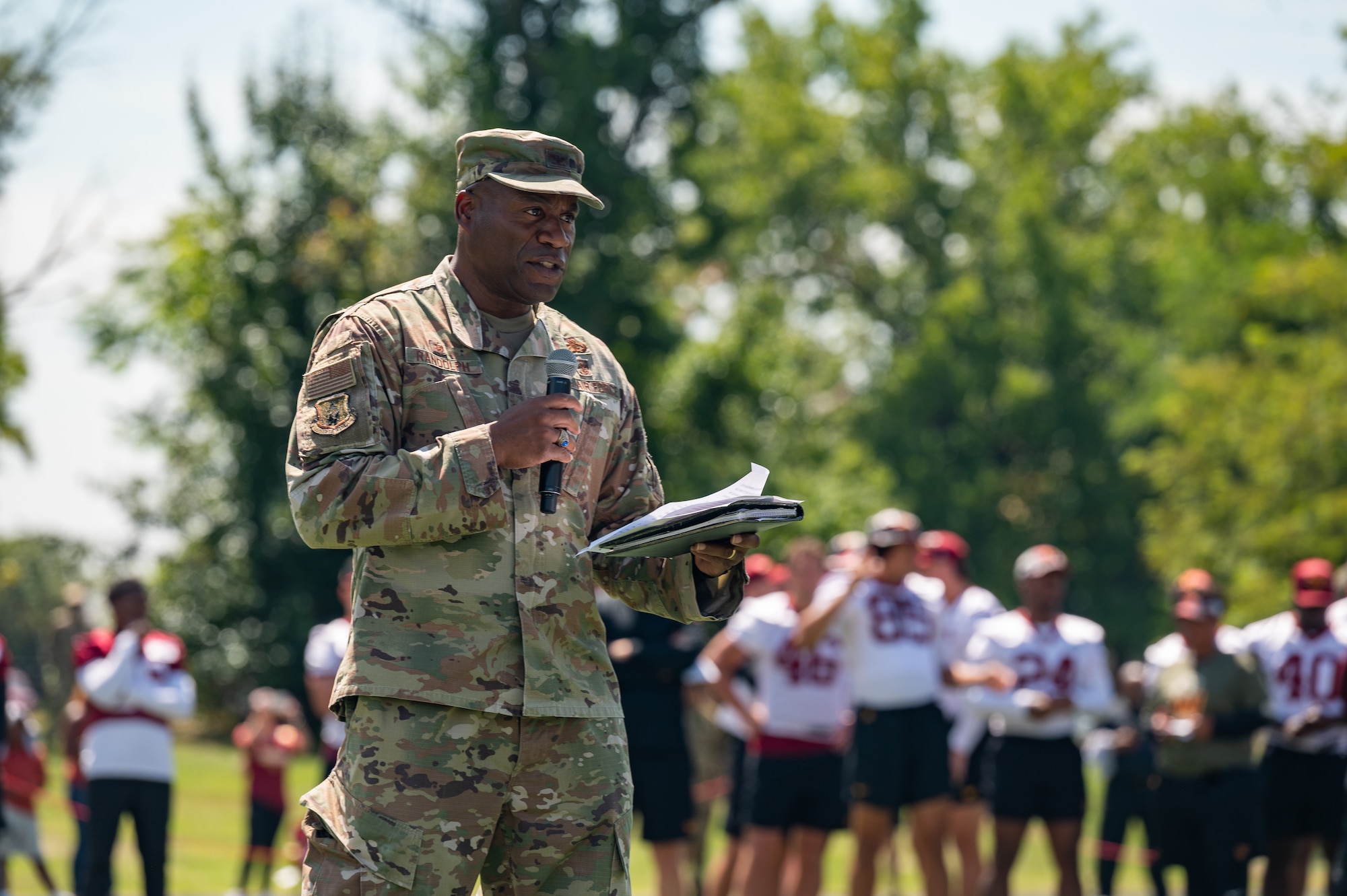 U.S. Air Force Col. Todd Randolph, commander, 316th Wing, provides opening remarks to the Washington Commanders football team open practice held at Joint Base Andrews, Maryland, Aug. 25, 2023. As part of a partnership between the Washington Commanders and U.S. Air Force, an Air National Guard patch will be featured on the Commanders defensive players’ practice jerseys this season to help garner exposure for recruiting the next generation of Airmen. (U.S. Air National Guard photo by Tech. Sgt. Sarah M. McClanahan)