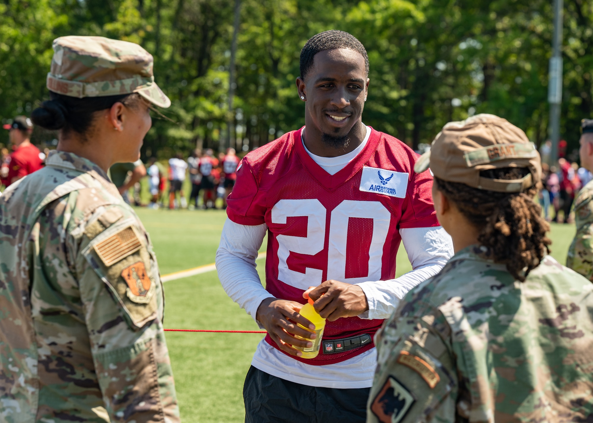 Jartavius Martin, center, defensive back, Washington Commanders football team, speaks to U.S. Air Force Master Sgt. Tatiana Collins, left, Air National Guard (ANG) marketing and advertising non-commissioned officer, National Guard Bureau (NGB), and Master Sgt. Jasmine Grant, ANG events NCO, NGB, during an open practice held at Joint Base Andrews, Maryland, Aug. 25, 2023. As part of a partnership between the Washington Commanders and U.S. Air Force, an Air National Guard patch will be featured on the Commanders defensive players’ practice jerseys this season to help garner exposure for recruiting the next generation of Airmen. (U.S. Air National Guard photo by Tech. Sgt. Sarah M. McClanahan)