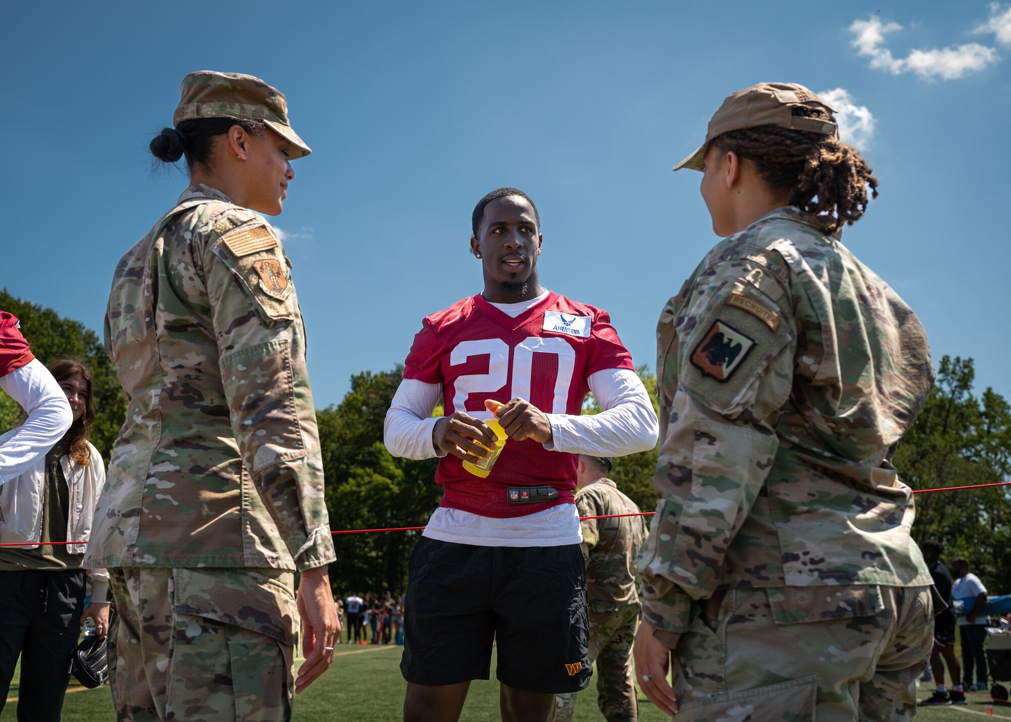 Jartavius Martin, center, defensive back, Washington Commanders football team, speaks to U.S. Air Force Master Sgt. Tatiana Collins, left, Air National Guard (ANG) marketing and advertising non-commissioned officer, National Guard Bureau (NGB), and Master Sgt. Jasmine Grant, ANG events NCO, NGB, during an open practice held at Joint Base Andrews, Maryland, Aug. 25, 2023. As part of a partnership between the Washington Commanders and U.S. Air Force, an Air National Guard patch will be featured on the Commanders defensive players’ practice jerseys this season to help garner exposure for recruiting the next generation of Airmen. (U.S. Air National Guard photo by Tech. Sgt. Sarah M. McClanahan)
