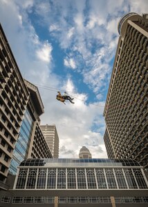 A U.S. Air Force pararescueman executes an urban high-angle ropes scenario to reach a simulated injured service member, render medical care, and lower him to safety during the 2023 PJ Rodeo competition in Louisville, Ky., Sept. 6, 2023. The biennial event, which tests the capabilities of pararescue Airmen across the service, was hosted by the Kentucky Air National Guard’s 123rd Special Tactics Squadron. (U.S. Air National Guard photo by Dale Greer)