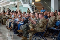 Military members applaud during ceremony