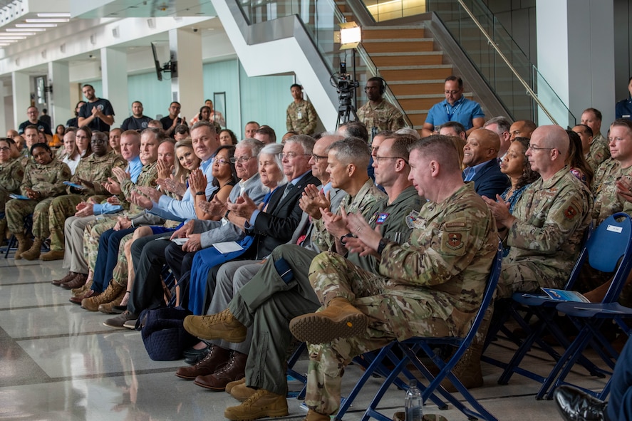 Military members applaud during ceremony