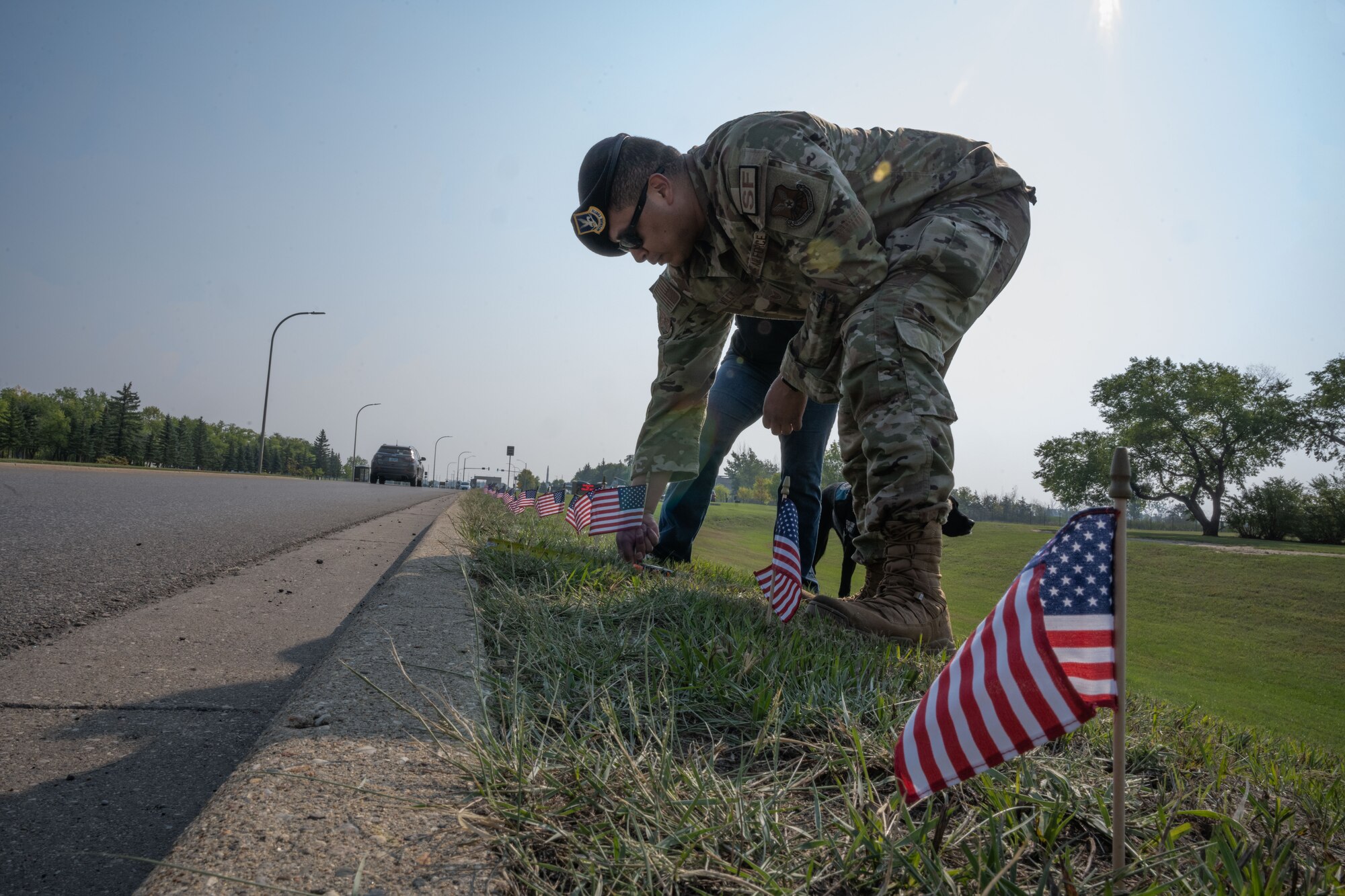 U.S. Air Force Staff Sgt. Alberto Villa, 91st Security Forces Group, evaluator, plants a flag at Minot Air Force Base, North Dakota, Sept. 6, 2023. More than 62 Airmen volunteered for the third annual flag planting event for Suicide Prevention Month. (U.S. Air Force photo by Airman 1st Class Trust Tate)