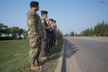 Team Minot Airmen line up shoulder-to-shoulder in preparation of planting flags at Minot Air Force Base, North Dakota, Sept. 6, 2023. The Airman volunteered to plant the flags for the third annual flag planting ceremony for Suicide Prevention Month. (U.S. Air Force photo by Airman 1st Class Trust Tate)