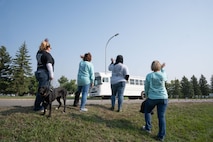 Civilian employees from the Integrated Primary Prevention office wave goodbye to Team Minot Airmen at Minot Air Force Base, North Dakota, Sept. 6, 2023. The IPP office organized the third annual flag planting for Suicide Prevention Month to bring awareness and increase team unity. (U.S. Air Force photo by Airman 1st Class Trust Tate)