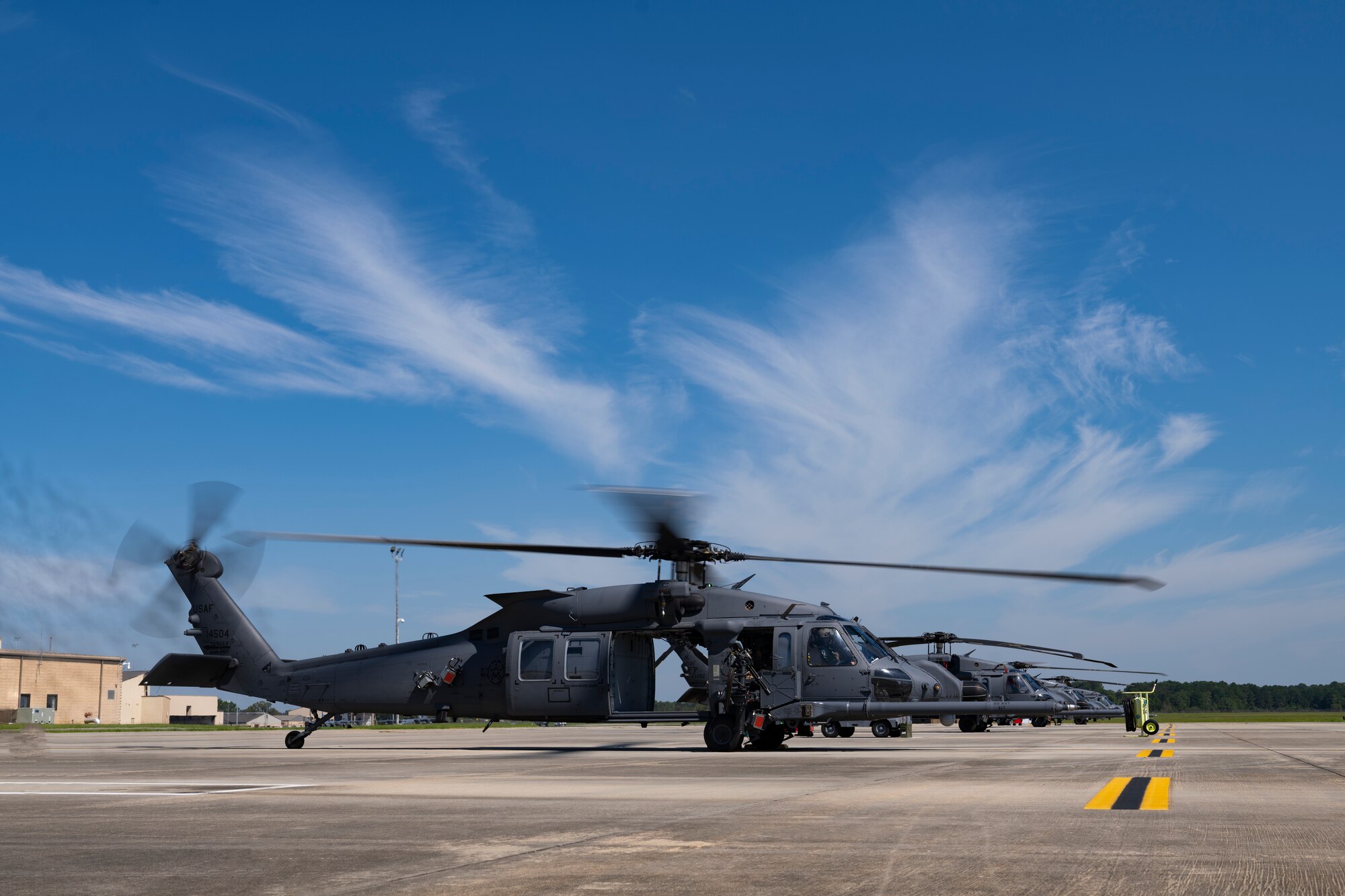 Gray helicopter sits on the flight line before take off