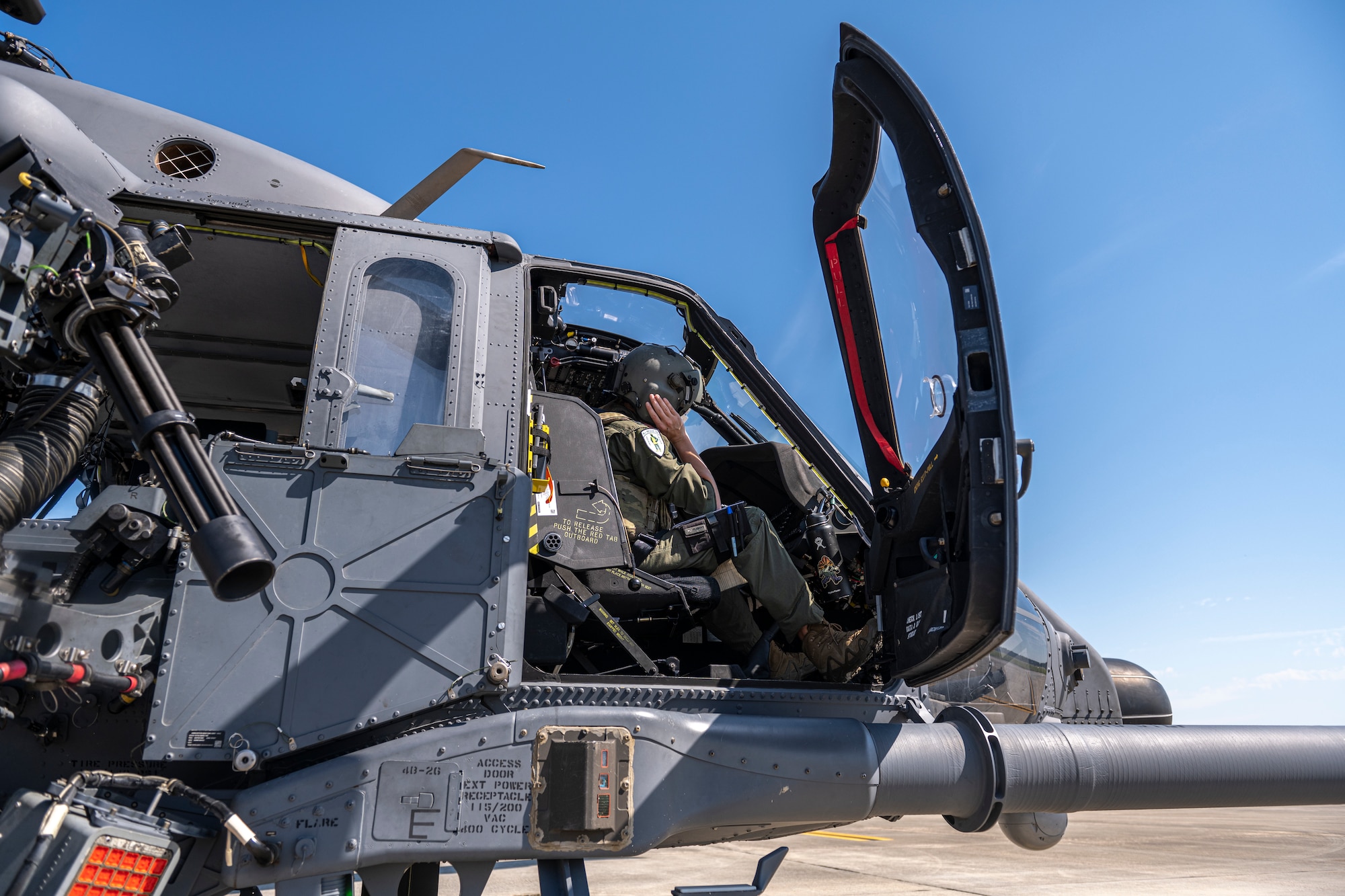 grey helicopter sits on the flight line before take off