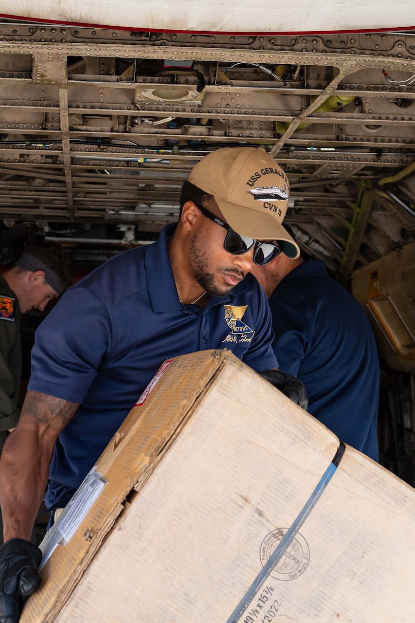 Logistics Specialist 2nd Class Dametri Allen, Supply Department of USS Gerald R. Ford (CVN 78), loads cargo onto a C-2A Greyhound assigned to Detachment Two of the Fleet Logistics Support Squadron 40 destined for Gerald R. Ford, Aug. 31, 2023.
