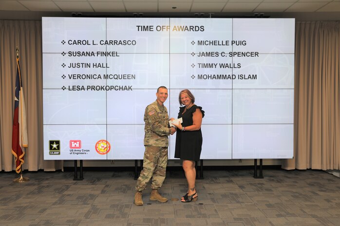 Col. Rhett Blackmon, U.S. Army Corps of Engineers (USACE), Galveston District (SWG) commander, presents Lesa Prokopchak, SWG Programs & Project Management Division admin. support assistant,  with a time off award for volunteering with the SWG Corps Day recreation committee, during the SWG Fiscal Year 2023, 4th Quarter Army Professional Awards Ceremony and Townhall at the Jadwin Building in Galveston, Texas, Sept. 7, 2023.
