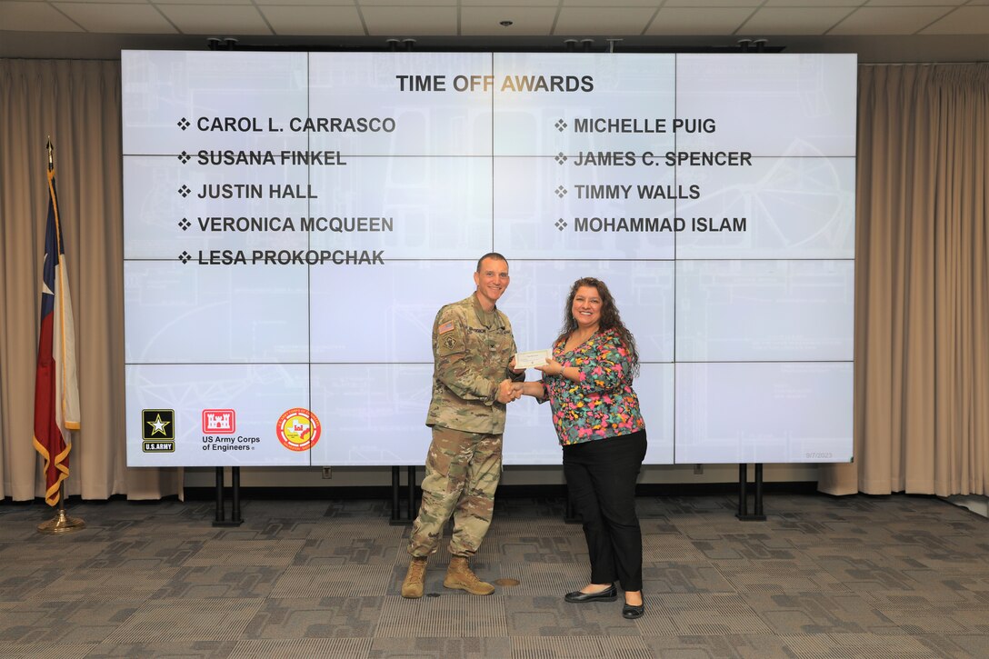 Col. Rhett Blackmon, U.S. Army Corps of Engineers (USACE), Galveston District (SWG) commander, presents a time off award to Carol Carrasco, Mega Project Division admin. officer, during the SWG Fiscal Year 2023, 4th Quarter Army Professional Awards Ceremony and Townhall at the Jadwin Building in Galveston, Texas, Sept. 7, 2023.