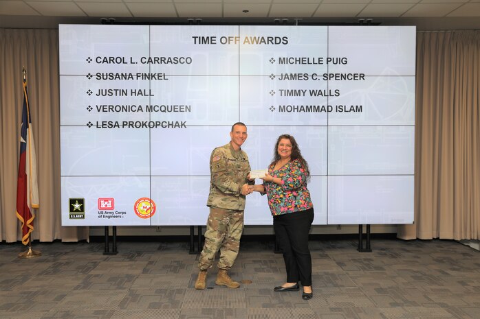 Col. Rhett Blackmon, U.S. Army Corps of Engineers (USACE), Galveston District (SWG) commander, presents a time off award to Carol Carrasco, Mega Project Division admin. officer, during the SWG Fiscal Year 2023, 4th Quarter Army Professional Awards Ceremony and Townhall at the Jadwin Building in Galveston, Texas, Sept. 7, 2023.