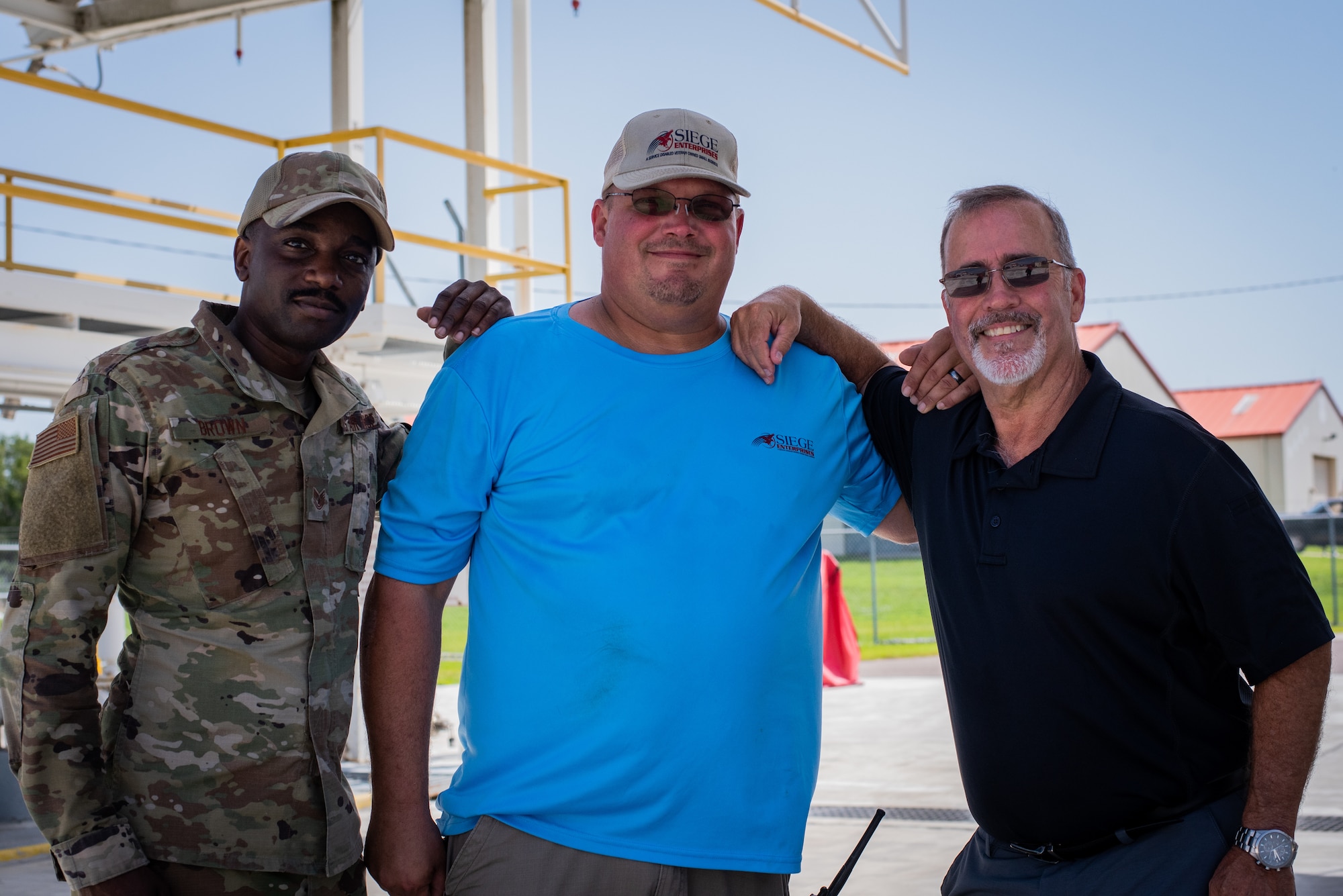 From left, U.S. Air Force Tech. Sgt. Spencer Brown, Defense Logistics Agency (DLA) Quality Assurance Representative, Brian Sutton, SIEGE Enterprises fuel distribution system operator, and Ronnie Brock, DLA Energy Quality Assurance and Contracting officer’s Representative, pose for a photo at MacDill Air Force Base, Florida, August 22, 2023.
