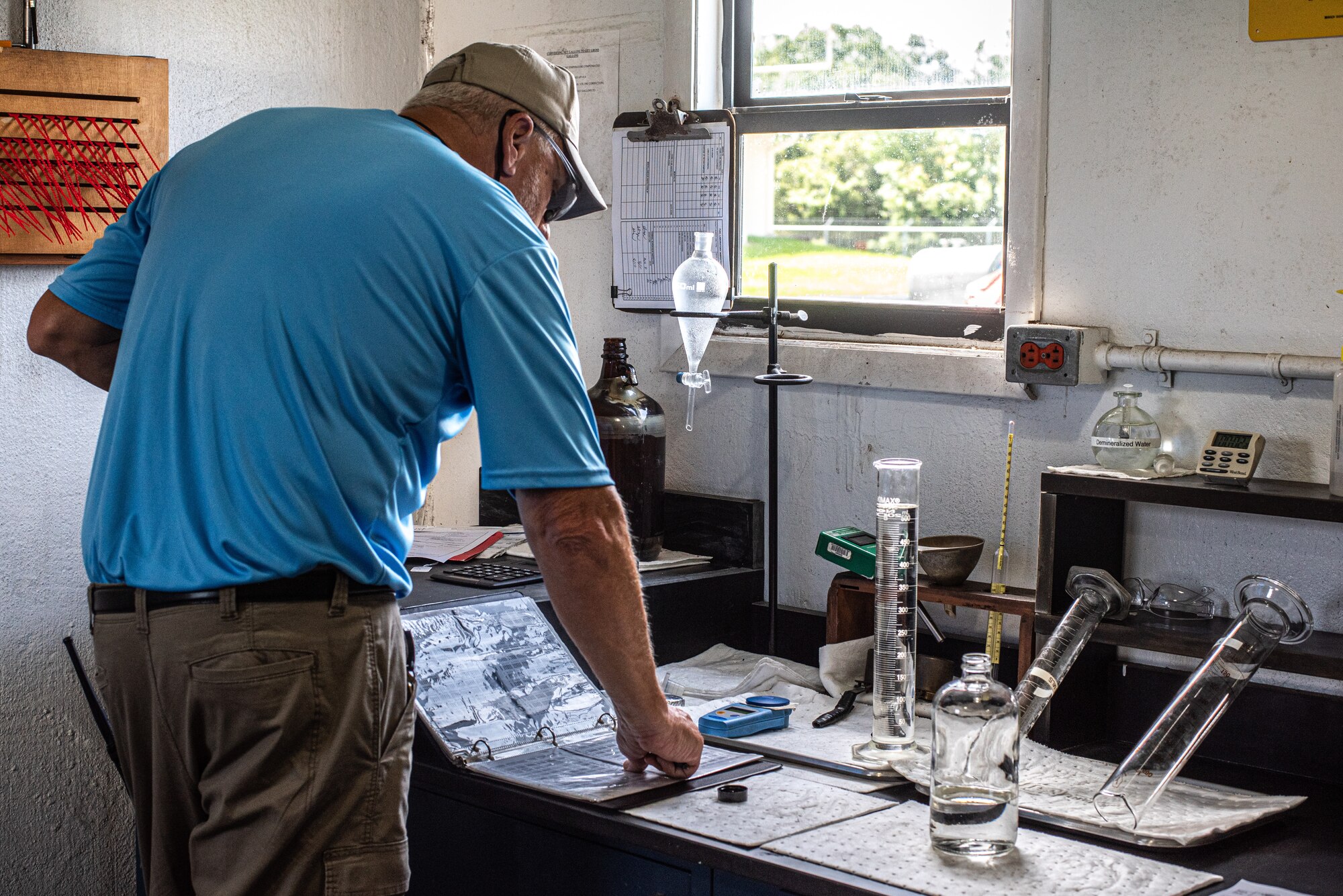 Bill Campbell, SIEGE Enterprises fuel distribution system operator, collects a sample of jet fuel to use in a conductivity check at MacDill Air Force Base, Florida, August 22, 2023.