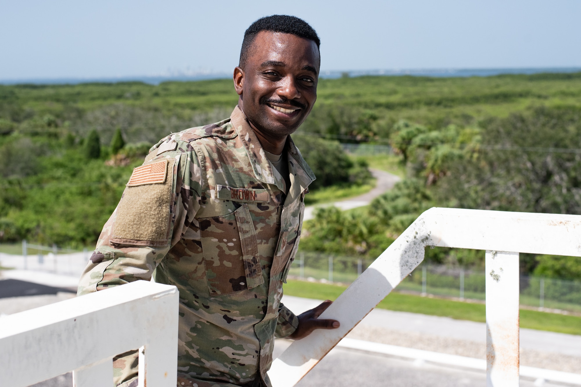U.S. Air Force Tech. Sgt. Spencer Brown Defense Logistics Agency Quality Assurance Representative poses at the top of a fuel storage tank at DFSP Tampa located on MacDill Air Force Base, Florida, August 22, 2023.