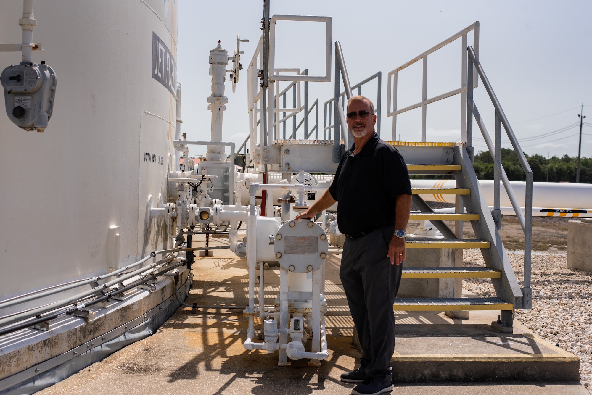 Ronnie Brock, Quality Assurance and Contracting officer’s Representative, poses near equipment at the Defense Duels Support Point at MacDill Air Force Base, Florida, August 22, 2023