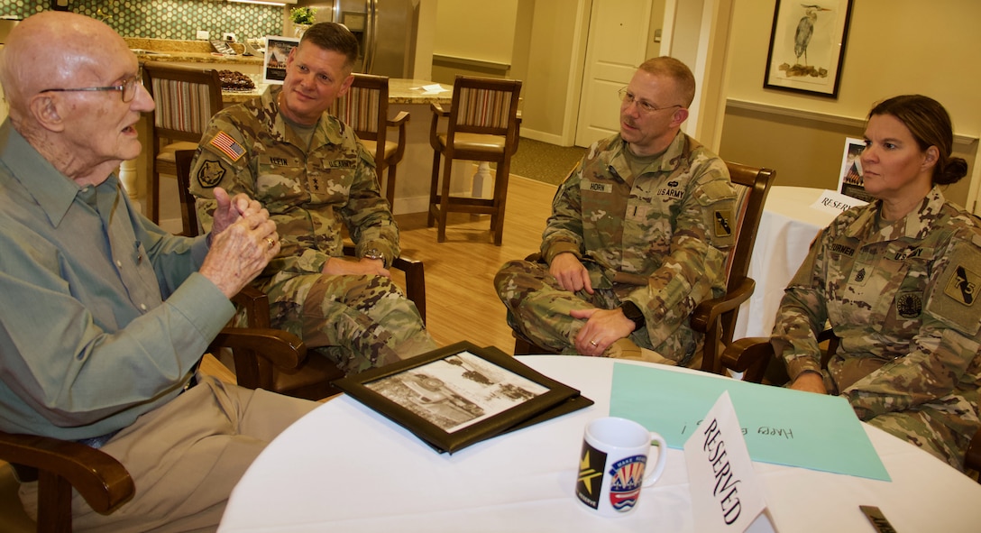 Frank Chambers, a World War II veteran who served with the 75th Division during the Battle of the Bulge, celebrates his 100th birthday in part with Maj. Gen. Marty Klein, Chief Warrant Officer 5 John Horn, and Command Sgt. Maj. Sherri Turner, at his home in League City, Texas.