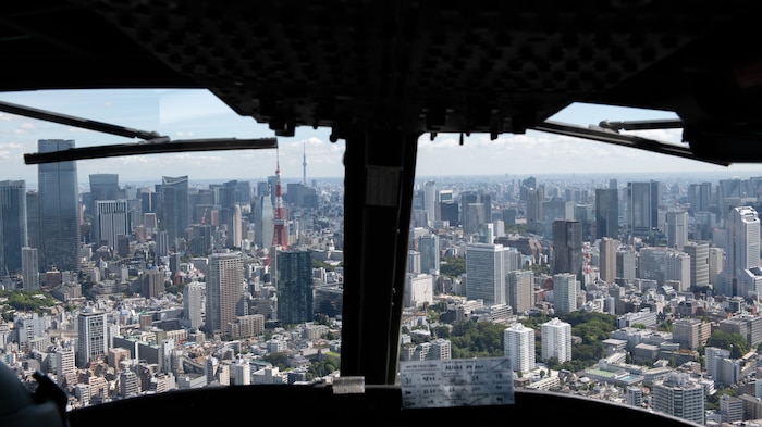 A UH-1N Huey flies through Tokyo airspace.
