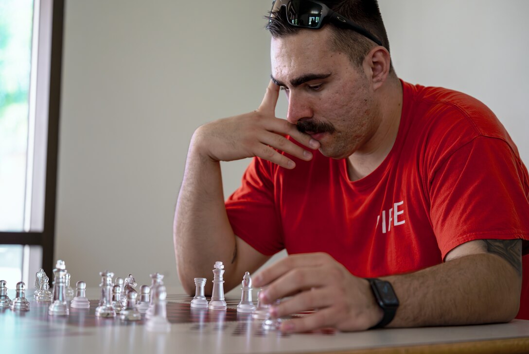 Man plays game of chess