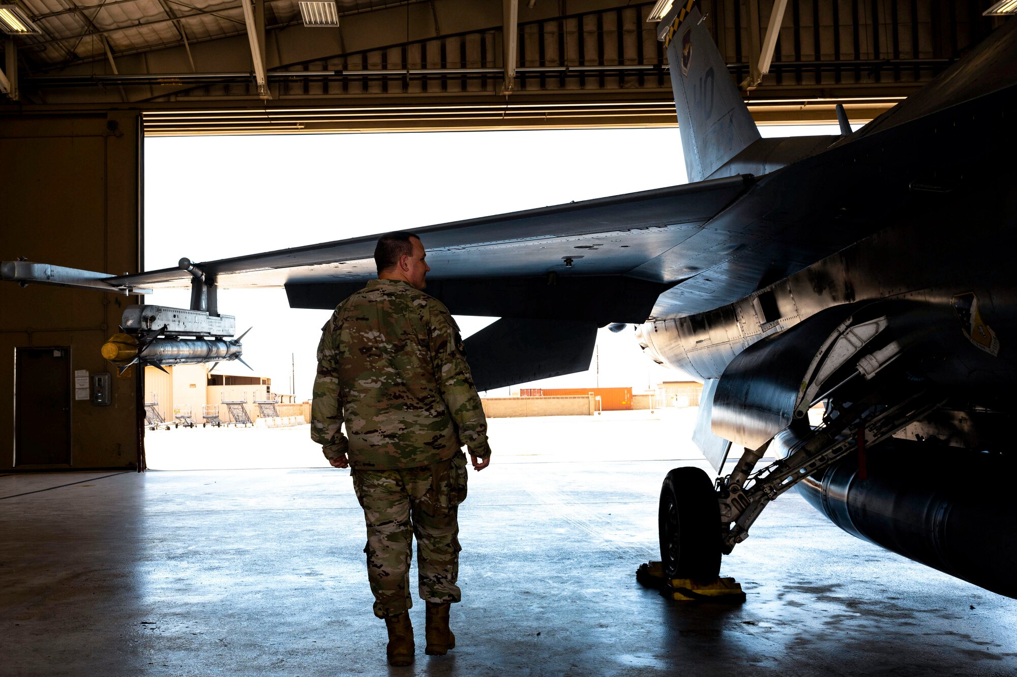U.S. Air Force Staff. Sgt. Nicholas Clum, 314th Fighter Squadron aviation resource management noncommissioned officer in charge, takes a tour of the flightline and observes a grounded F-16 Viper at Holloman Air Force Base, New Mexico, Aug. 29, 2023. From the earliest stages of mission planning to the return of the aircraft and crew, SARMs serve as those responsible for ensuring airborne operations are executed efficiently and safely. (U.S. Air Force photo by Airman 1st Class Isaiah Pedrazzini)
