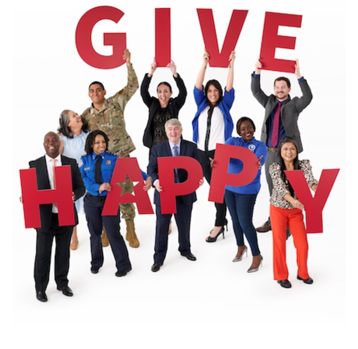 Federal employees from various agencies standing together holding the letters G-I-V-E H-A-P-P-Y and text: “Donate today at GiveCFC.org