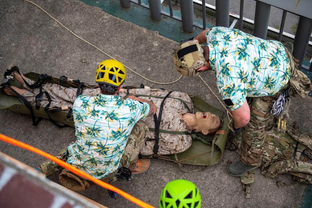 U.S. Air Force pararescuemen execute an urban high-angle ropes scenario to reach a simulated injured service member, render medical care, and lower him to safety during the PJ Rodeo competition in Louisville, Ky., Sept. 6, 2023. The biennial event, which tests the capabilities of pararescue Airmen across the service, was hosted by the Kentucky Air National Guard’s 123rd Special Tactics Squadron. (U.S. Air National Guard photo by Senior Airman Madison Beichler)