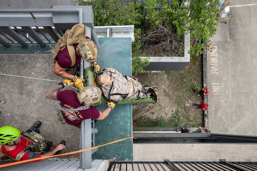 U.S. Air Force pararescuemen execute an urban high-angle ropes scenario to reach a simulated injured service member, render medical care, and lower him to safety during the 2023 PJ Rodeo competition in Louisville, Ky., Sept. 6, 2023. The biennial event, which tests the capabilities of pararescue Airmen across the service, was hosted by the Kentucky Air National Guard’s 123rd Special Tactics Squadron. (U.S. Air National Guard photo by Dale Greer)