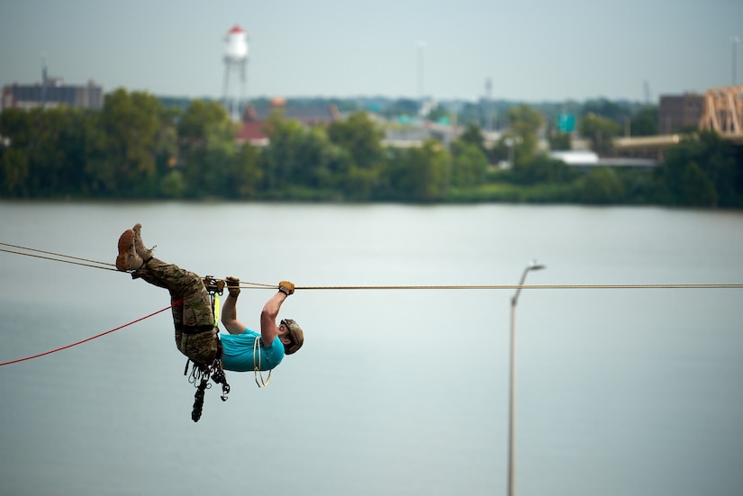 A U.S. Air Force pararescueman executes an urban high-angle ropes scenario to reach a simulated injured service member, render medical care, and lower him to safety during the PJ Rodeo competition in Louisville, Ky., Sept. 6, 2023. The biennial event, which tests the capabilities of pararescue Airmen across the service, was hosted by the Kentucky Air National Guard’s 123rd Special Tactics Squadron. (U.S. Air National Guard photo by Phil Speck)