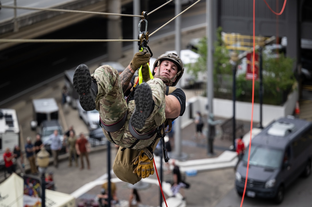 A U.S. Air Force pararescueman executes an urban high-angle ropes scenario to reach a simulated injured service member, render medical care, and lower him to safety during the 2023 PJ Rodeo competition in Louisville, Ky., Sept. 6, 2023. The biennial event, which tests the capabilities of pararescue Airmen across the service, was hosted by the Kentucky Air National Guard’s 123rd Special Tactics Squadron. (U.S. Air National Guard photo by Dale Greer)