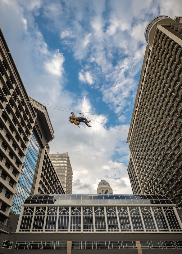 A U.S. Air Force pararescueman executes an urban high-angle ropes scenario to reach a simulated injured service member, render medical care, and lower him to safety during the 2023 PJ Rodeo competition in Louisville, Ky., Sept. 6, 2023. The biennial event, which tests the capabilities of pararescue Airmen across the service, was hosted by the Kentucky Air National Guard’s 123rd Special Tactics Squadron. (U.S. Air National Guard photo by Dale Greer)